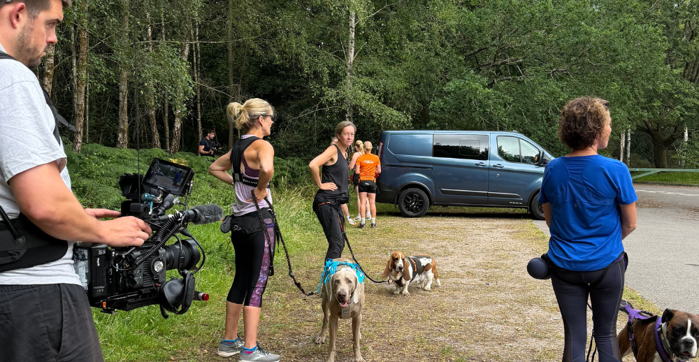 Group of people waiting with their dogs at the start of filming